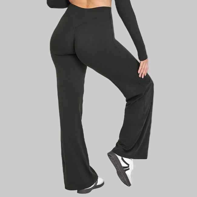 Person wearing black wide-leg pants on a white background